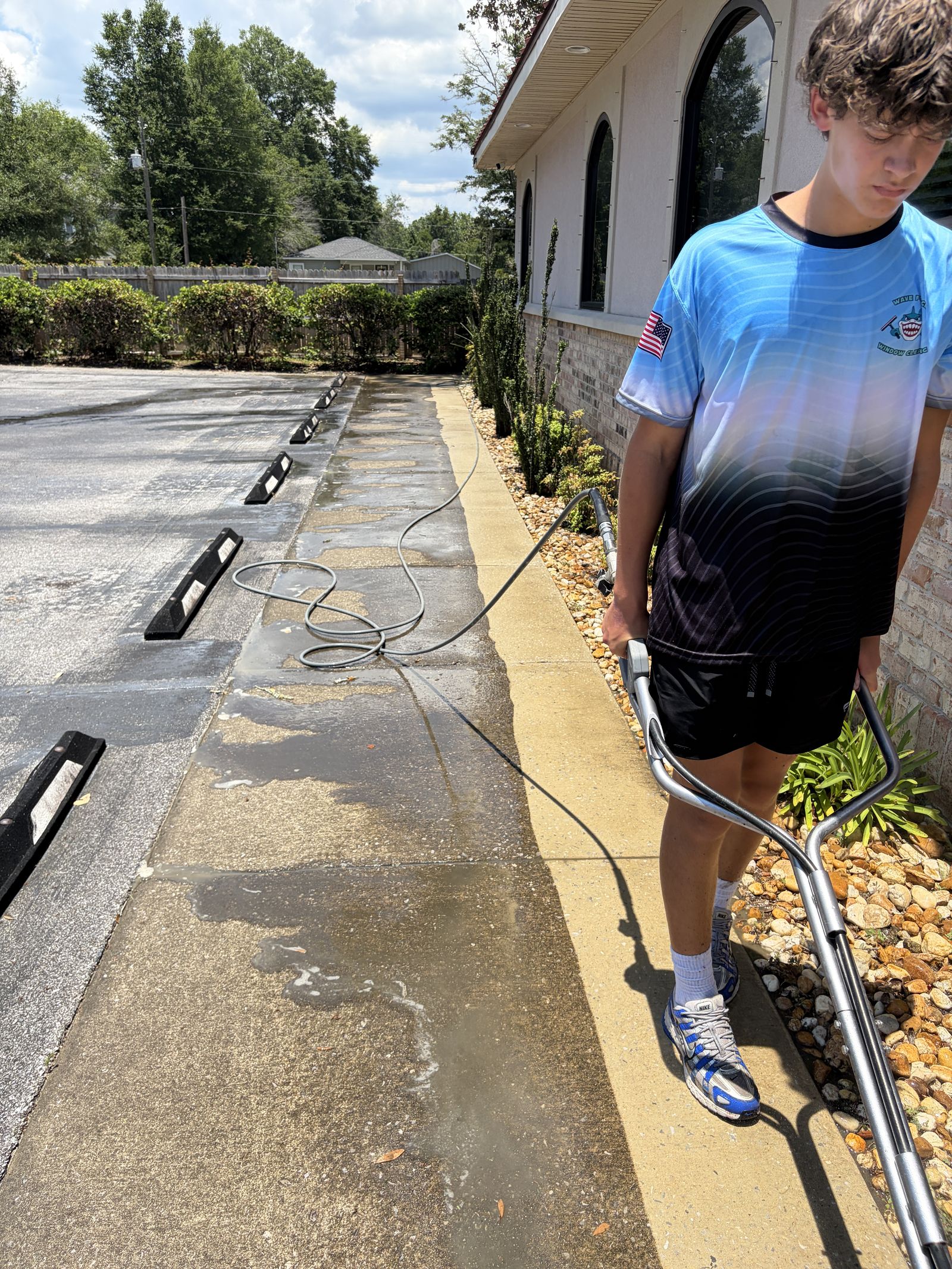 Commercial pressure washing of a walkway with a surface cleaner