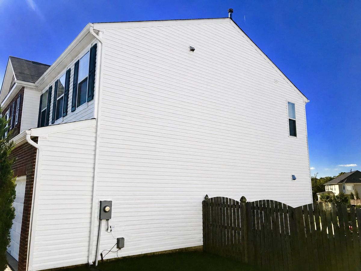 Vinyl siding clean and white after low-pressure house washing