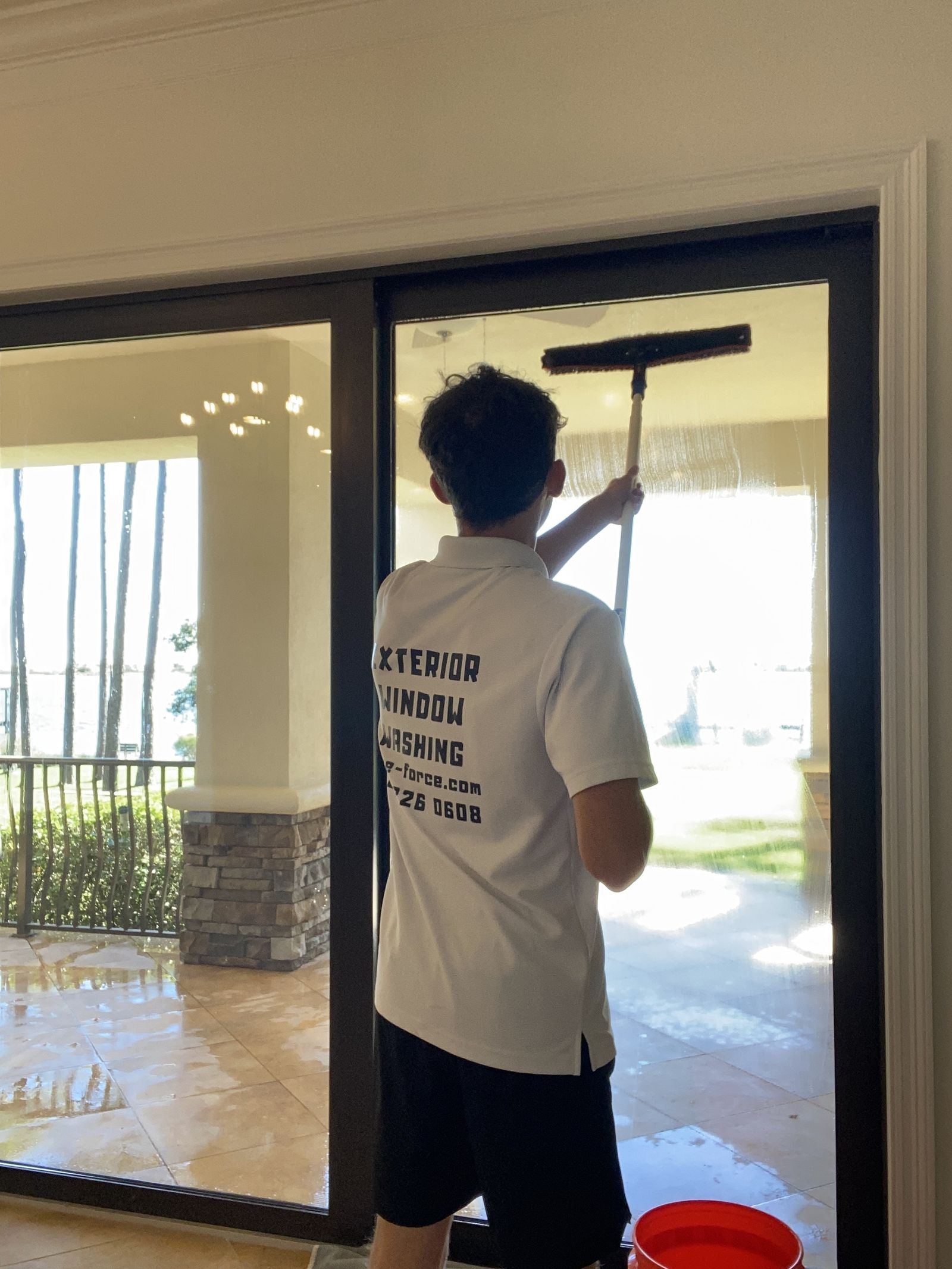 Wave Force technician cleaning an interior sliding glass door