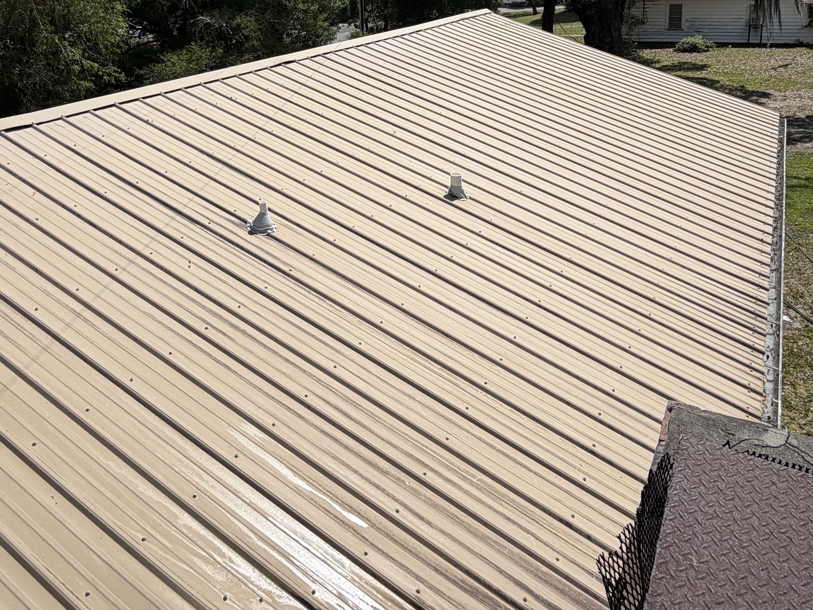 Metal roof panels clean and uniform after soft wash roof washing