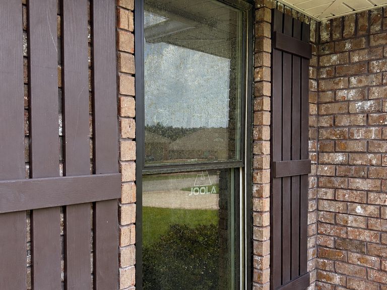 Exterior window with dirty, hazy glass before professional window cleaning